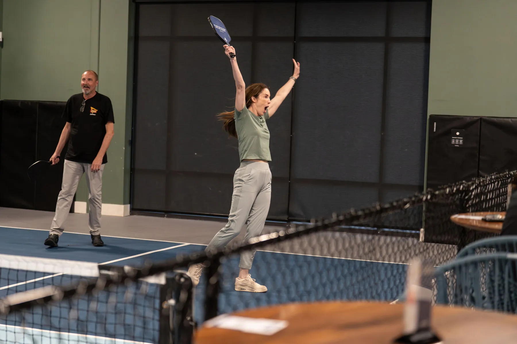 A guest celebrates a pickleball point at a private event