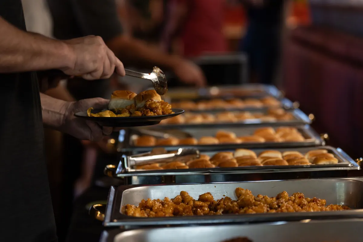 A catering line being plated at a private event