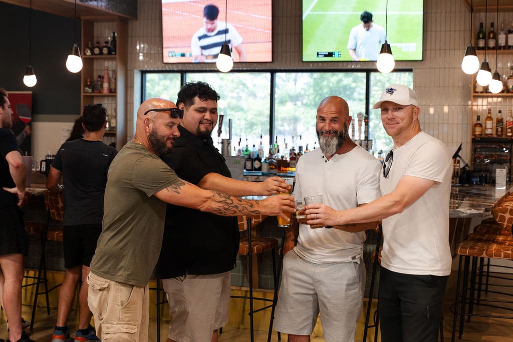 Guests toasting at the At Fault bar in Dallas