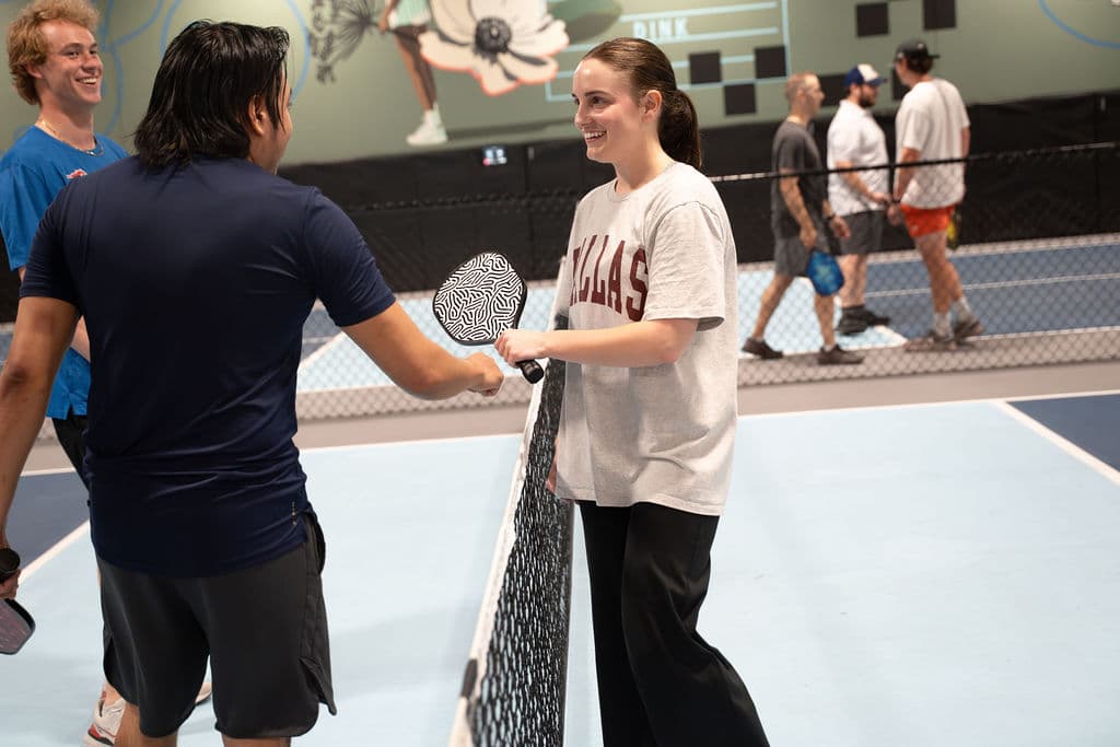 Corporate guests playing pickleball at a team event